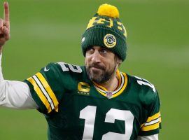 Aaron Rodgers celebrates a Green Bay Packers playoff victory at Lambeau Field, but will the Packers honor his trade request? (Image: Matt Ludtke/AP)