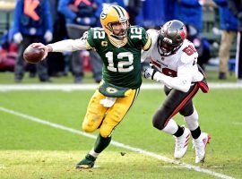 Aaron Rodgers from the Green Bay Packers is chased down from a defender from the Tampa Bay Bucs in last yearâ€™s NFC Championship. (Image: Benny Sieu/USA Today Sports)