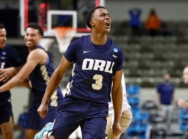 Max Abmas, a sophomore guard from Oral Roberts, celebrates an upset victory over Florida in 2021 March Madness. (Image: Getty)