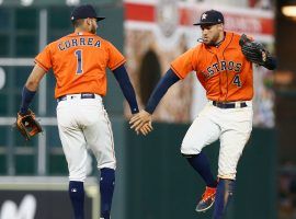 Carlos Correa and George Springer celebrate during the Houston Astros’ 7-4 win over the Kansas City Royals on Sunday, the team’s 11th consecutive victory. (Image: Bob Levey/Getty)