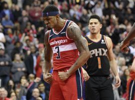 Washington Wizards guard Bradley Beal celebrates a triple-overtime victory over the Phoenix Suns with guard Devin Booker (1) in the background in 2018. (AP Photo/Nick Wass)