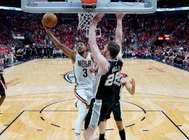 CJ McCollum from the New Orleans Pelicans drives the lane against Jakob Poeltl from the San Antonio Spurs in the Play-In Tournament. (Image: Getty)