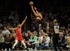 Devin Booker from the Phoenix Suns shoots over CJ McCollum of the New Orleans Pelicans in Game 1 of their first-round playoff series. (Image: Getty)