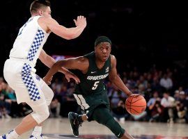 Michigan State point guard Cassius Winston is defended by Kentucky forward Nate Sestina at the Champions Classic at Madison Square Garden in NYC. (Image: Adam Hunger/AP)