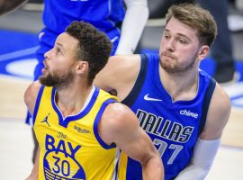 Steph Curry from the Golden State Warriors boxes out Luka Doncic from the Dallas Mavs, but the two All-Stars square off for the Western Conference crown. (Image: Porter Lambert/Getty)