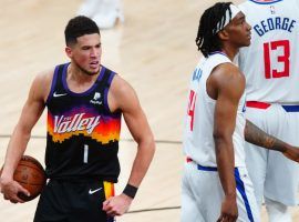 Devin Booker of the Phoenix Suns flexes after he notches his first-career triple-double with a game-high 40 points in a Game 1 victory over the LA Clippers. (Image: Porter Lambert/Getty)