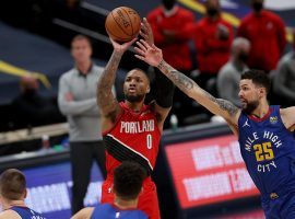 Damian Lillard of the Portland Trail Blazers, seen here elevating for one of his record-setting 12 3-point shots, evades Austin Rivers of the Denver Nuggets. (Image: Porter Lambert/Getty)