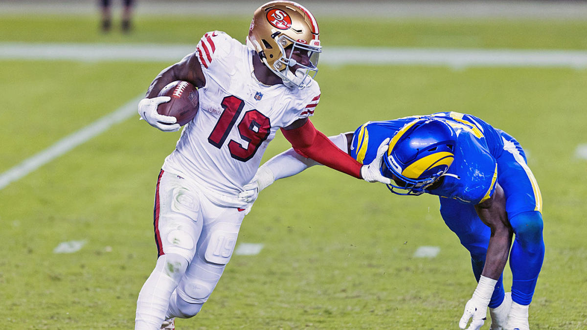 Deebo Samuel from the San Francisco 49ers stiff arms a defender from the LA Rams during an NFC West divisional tilt in 2021. (Image: Getty)