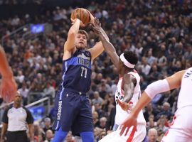 Luka Doncic, Dallas Mavericks rookie, shoots over OG Anunoby from the Toronto Raptors. (Image: Tom Szczerbowski/Getty Images)