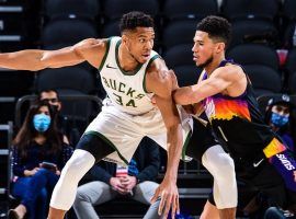 Devin Booker from the Phoenix Sus defends Giannis 'Greek Freak' Antetokounmpo from the Milwaukee Bucks. (Image: Getty)