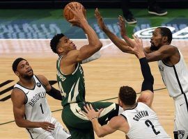 Giannis 'Greek Freak' Antetokounmpo from the Milwaukee Bucks attempts a shot in traffic against Kevin Durant and other members of the Brooklyn Nets. (Image: Getty)