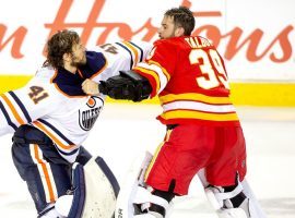 Edmonton Oilers Goalie Mike Smith (white) fights Calgary Flames goalie Cam Talbot at the Saddledome in Calgary, Alberta, Canada. (Image: Derek Leung/Getty)