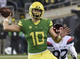 Quarterback Justin Herbert of the Oregon Ducks throwing a pass against Utah. (Image: Steve Dykes/Getty)