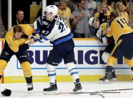 Nashville's Colton Sissons (left) and Winnipeg's Nikolaj Ehlers (right) tussle in a line fight during an intense division game (Image: AP)