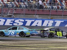 Jimmy Johnson (48) attempted to pass Martin Truex Jr. (78) on the final turn at Charlotte Motor Speedway, resulting in a crash that eliminated Johnson from the NASCAR playoffs. (Image: Chuck Burton/AP)