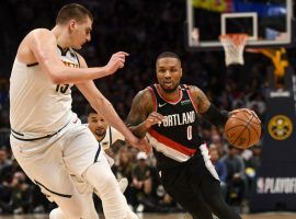 Nikola Jokic of the Denver Nuggets defends a driving Damian Lillard from the Portland Trail Blazers. (Image: Porter Lambert/Getty)