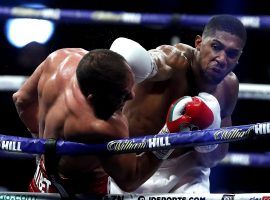 Anthony Joshua (right) knocked out Kubrat Pulev (left) to retain his heavyweight titles on Saturday. (Image: Andrew Couldridge/PA/Getty)