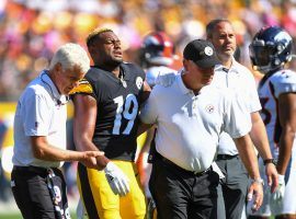 Trainers from the Pittsburgh Steelers assist wide receiver JuJu Smith-Schuster off the field after a shoulder injury knocked him out of Week 5. (Image: Joe Sargent)