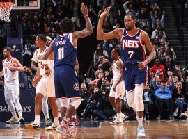 Kyrie Irving from the Brooklyn Nets gives teammate Kevin Durant a high-five after he completed a three-point play against the Cleveland Cavs. (Image: Getty)