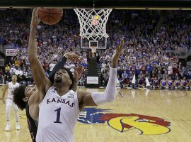 Dedric Lawson (1) of Kansas goes in for a layup against New Mexico Stateâ€™s C.J. Bobbitt during a game between the two teams on Dec. 8. (Image: Charlie Riedel/AP).