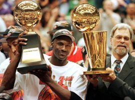 Michael Jordan and head coach Phil Jackson celebrate their victory in the 1998 NBA Finals. (Image: Jeff Haynes/Getty)