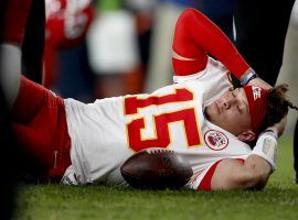 Medical staff attend to KC Chiefs QB Patrick Mahomes after injuring his knee against the Denver Broncos on Thursday Night Football. (Image: Porter Lambert/Getty)