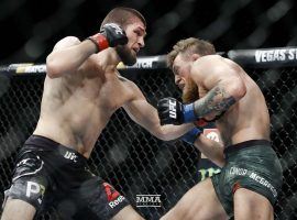 Khabib Nurmagomedov (left) lands a punch on Conor McGregor (right) during their UFC 229 lightweight title fight in October 2018. (Image: Esther Lin/MMA Fighting)