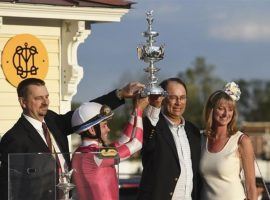 Rombauer trainer Mike McCarthy, jockey Flavien Prat and owners John and Diane Fradkin hoist the Woodlawn Vase replica after Rombauer's Preakness Stakes victory Saturday. The colt heads to Belmont Park for a likely date in the June 5 Belmont Stakes. (Image: AP Photo/Will Newton)