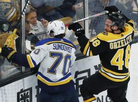 Oskar Sundqvist of the St. Louis Blues and Matt Grzelcyk of the Boston Bruins scrap in the corner of a Stanley Cup Finals game in Boston. (Image: Jim Davis/Boston Globe)