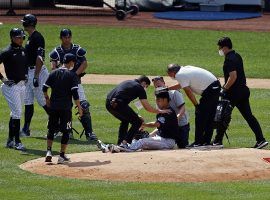 Medical staff attend to Masahiro Tanaka (ground) after struck by a batted ball by teammate, Giancarlo Stanton (far left). (Image: Adam Hunger/AP)