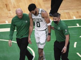 Boston Celtics trainers help Jayson Tatum off the court in Game 3 against the Miami Jeat when he suffered a neck injury, but heâ€™s expected to play in Game 4. (Image: Getty)