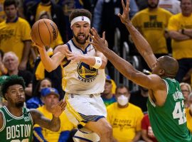 Golden State Warriors guard Klay Thompson passes out of a double team from Al Horford and Marcus Smart from the Celtics. (Image: Getty)