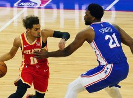 Trae Young of the Atlanta Hawks scoots by Joel Embiid from the Philadelphia 76ers. (Image: James Lang/USA Today Sports)