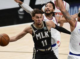 Trae Young of the Atlanta Hawks drives the lane against Derrick Rose and Obi Toppin from the New York Knicks in Game 4 at State Farm Arena in Atlanta. (Image: Getty)