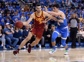 USC Trojans guard Nick Rakocevic drives by UCLA Bruins guard Jaime Jaquez at Pauley Pavilion in West LA. (Image: Keith Birmingham/AP)