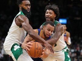 Steph Curry from the Golden State Warriors gets harassed by Jaylen Brown and Marcus Smart of the Boston Celtics. (Image: Getty)