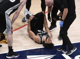 San Antonio Spurs guard Derrick White cringes in pain after he suffered an ankle injury against the Washington Wizards. (Image: Nick Wass/AP)