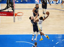 Golden State Warriors forward Andrew Wiggins soars over Luka Doncic from the Dallas Mavs for a thunderous dunk. (Image: Getty)