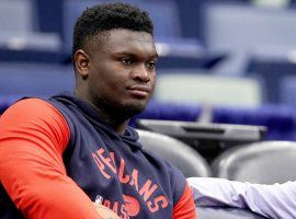 A dejected Zion Williamson from the New Orleans Pelicans sits on the sidelines with a foot injury while watching his teammates practice. (Image: Sean Gardner/Getty)