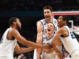 Villanova’s Dominic DiVincenzo is mobbed by teammates after the team won the NCAA Men’s Basketball Championship. (Image: USA Today Sports)