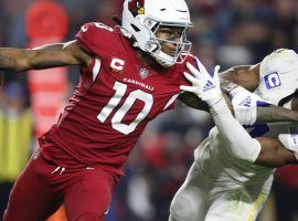 DeAndre Hopkins from the Arizona Cardinals stiff arms Jordan Fuller from the LA Rams during Monday Night Football in Week 14. (Image: Ralph Freso/AP)