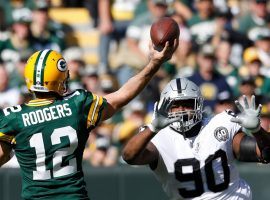 Green Bay QB Aaron Rodgers attacks the Oakland Raiders defense during a victory at Lambeau Field in Green Bay, WI. (Image: Jeffrey Phelps/AP)