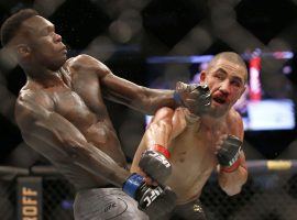 Israel Adesanya (left) will defend his middleweight title against former champion Robert Whittaker (right) in a rematch at UFC 271 on Saturday. (Image: Darrian Traynor/Getty)