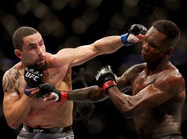 Israel Adesanya (right) did enough to earn a unanimous decision over Robert Whittaker (left) and defend his UFC middleweight title on Saturday night. (Image: Carmen Mandato/Getty)