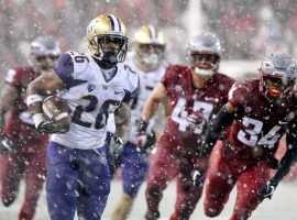 Washington running back Salvon Ahmed (26) evades Washington State defenders in the snow during UWâ€™s victory in the 2018 Apple Cup in Pullman, WA. (Image: James Snook/USA Today Sports)