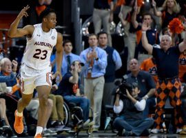 Auburn swingman Isaac Okoro (23) celebrates knocking down a three-pointer against Georgia. (Image: Julie Bennett/AP)