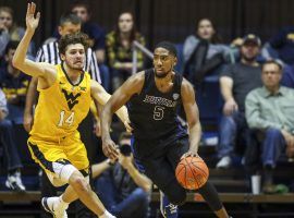 Buffalo Bulls guard CJ Massinburg drives around West Virginia's Chase Harler in Morgantown, West Virginia. (Image: Ben Queen/USA Today Sports)