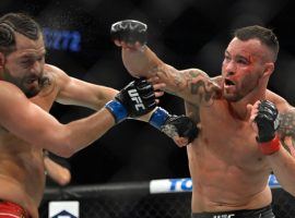 Jorge Masvidal (left) faces felony charges over an alleged assault of rival Colby Covington (right) in Miami. (Image: David Becker/Getty)