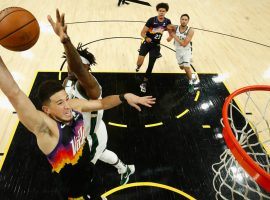 Devin Booker from the Phoenix Suns winds up a dunk against Jrue Holiday of the Milwaukee Bucks in Game 2 of the NBA Finals. (Image: Christian Petersen/Getty)