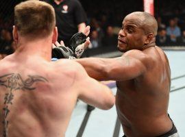 Daniel Cormier (right) lands a punch against Stipe Miocic during their UFC heavyweight championship bout at UFC 226, which was won by Cormier. (Image: Getty)